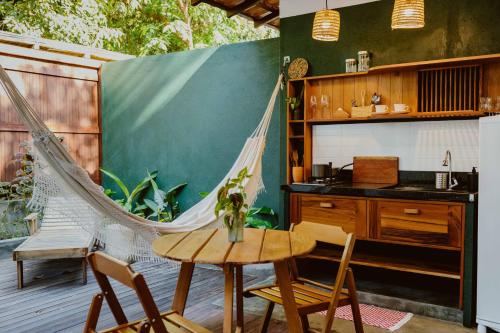 a patio with a hammock and a table and chairs at Recanto Alter do Chão in Alter do Chao