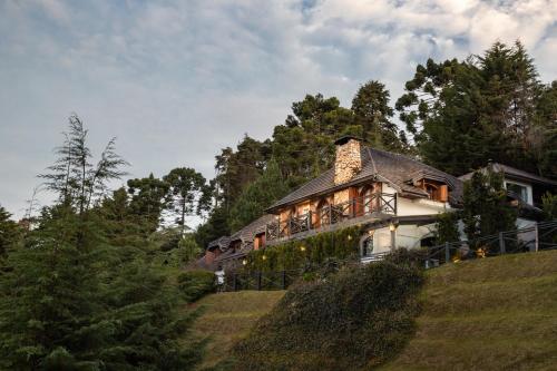 a large house on top of a hill at Alma Hotel in Campos do Jordão