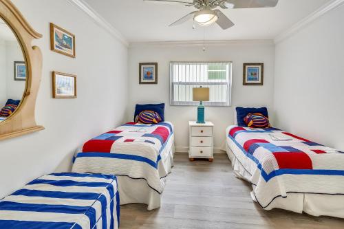 a bedroom with two beds and a mirror at Sunset Villas 2 in Clearwater Beach