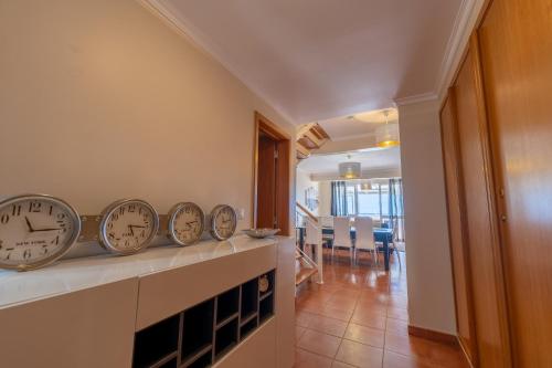 a row of clocks sitting on a counter in a room at Vista Mar in Porto Santo