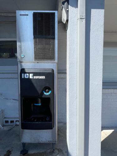 an ice box with a face on it next to a building at Budget Inn Madill in Madill