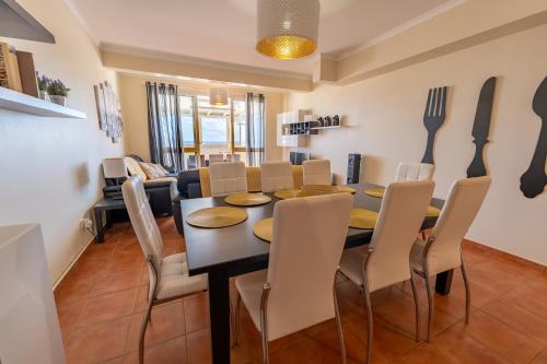 a dining room with a black table and chairs at Vista Mar in Porto Santo