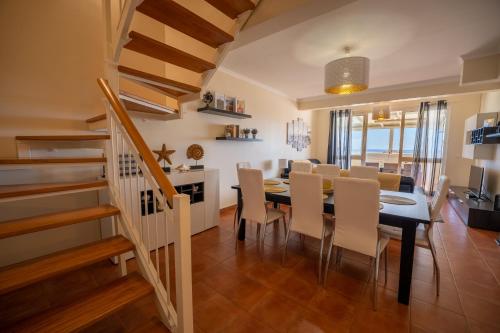 a dining room and kitchen with a table and chairs at Vista Mar in Porto Santo