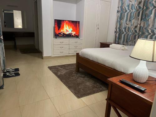 a bedroom with a bed with a fire in the wall at El Tessa garden/serviced apartment in Kisumu