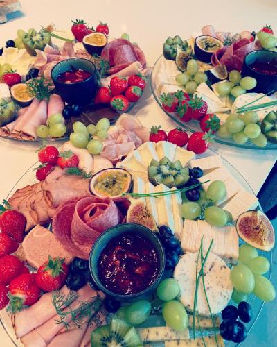 a table topped with lots of different types of cheese and fruit at B&B Biesvenhof in Merksplas