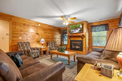 a living room with a couch and a fireplace at Poplar Point Condo Unit 12E in Pigeon Forge