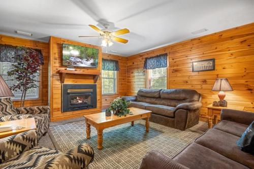 a living room filled with furniture and a fireplace at Poplar Point Condo Unit 12E in Pigeon Forge