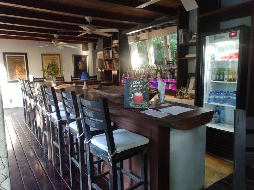 a bar in a restaurant with chairs around it at Monkey Casa Hotel in Trancoso