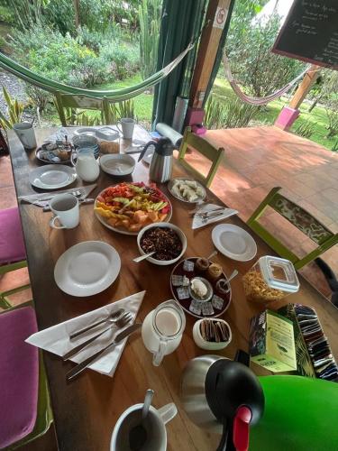 a wooden table with plates of food on it at Naturalmente Boutique Bungalows y Cocina Mediterránea in Las Lajas