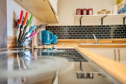a kitchen with a counter top and a sink at Cute 2 bed flat in the heart of Derby By 20Property Stays Short Lets & Serviced Accommodation in Derby