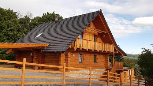a log cabin with a black roof at SrubNemo in Nemotice