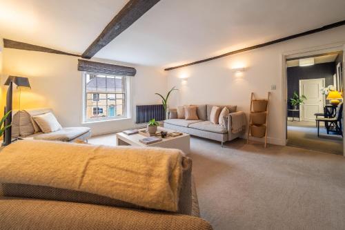 a living room with a couch and a table at Crown Street in Bury Saint Edmunds