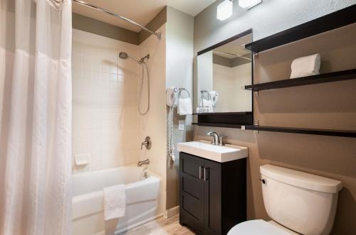 a bathroom with a toilet and a sink and a shower at Zephyr Mountain Lodge Premium-Rated 1102 in Winter Park