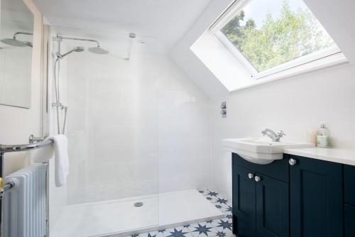 a bathroom with a shower and a sink at The White House in Duns