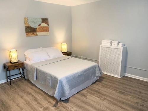 um quarto com uma cama branca e duas mesas de cabeceira em Modern cozy 1BD/1BA Apt in Federal Hill em Baltimore