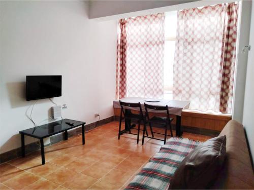 a living room with a table and a couch at Casa Terra Cota - Almada in Almada