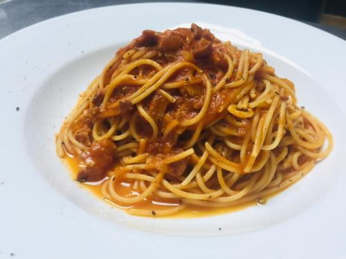 a plate of spaghetti on a white plate at Naturalmente Boutique Bungalows y Cocina Mediterránea in Las Lajas