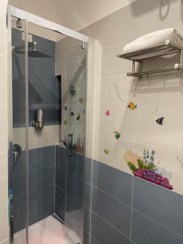 a bathroom with a shower with a glass door at Giulieda in Wonderland in Naples