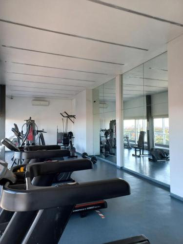 a gym with a row of treadmills and elliptical machines at Grace210 in Buenos Aires