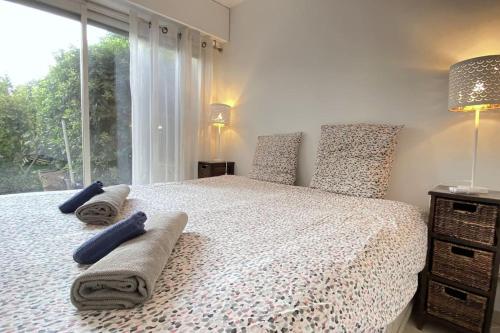 a bedroom with a bed with pillows and a window at Rabiac - Charming 1 bedroom with private garden in Antibes