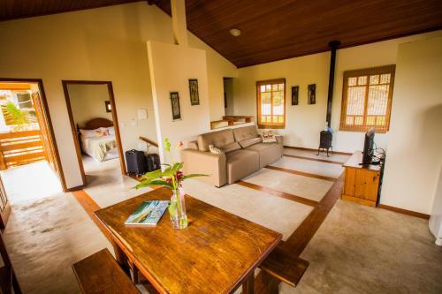 a living room with a couch and a table at Pousada Tulipane Florianopolis in Florianópolis