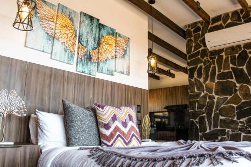 a bedroom with a bed and a stone wall at Oasis 444 in San Marcos