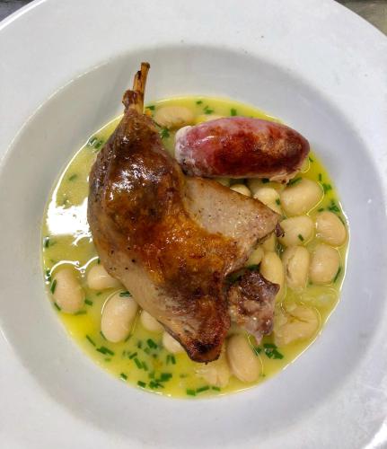 a white plate of food with meat and beans at The Gordon Arms Restaurant with Rooms in Yarrow