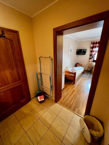 a room with a door leading to a bedroom at Penzion Zrzka in Kořenov