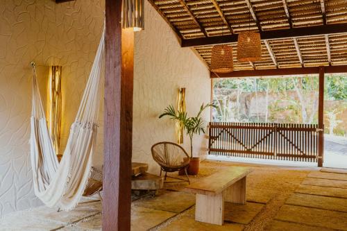 a room with a hammock and a table and a chair at Recanto Alter do Chão in Alter do Chao