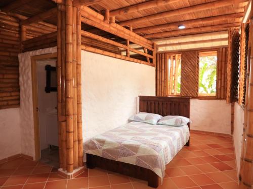 a bedroom with a bed in a room with wooden ceilings at Villa Jardines de la Monarca in Rivera