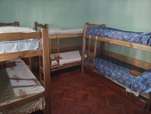 a room with three bunk beds in a room at HOSTEL ATG in Ciudad Lujan de Cuyo