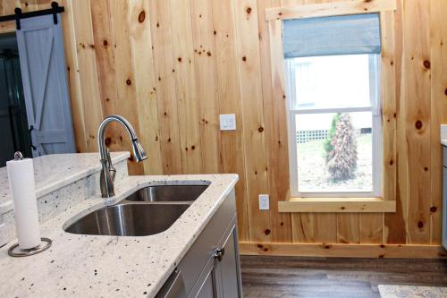 a kitchen with a sink and a window at Lake Winnisquam Getaway in Sanbornton