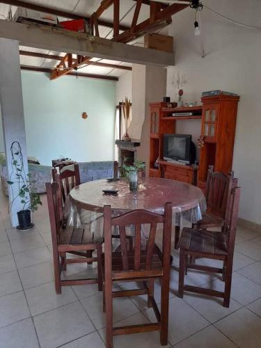a dining room with a table and chairs and a tv at Casa Carina in Yala