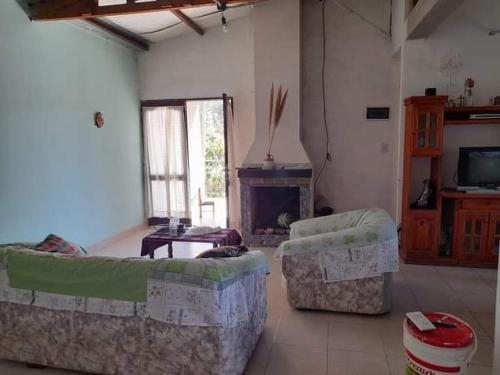a living room with two couches and a fireplace at Casa Carina in Yala