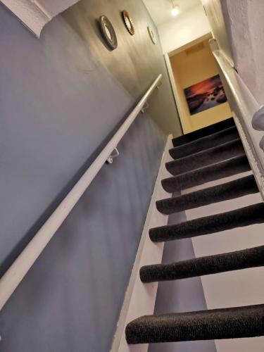 a staircase in a building with black and gray stairs at The Vacationers - Pvt Rooms with Shared Bath in Sunderland