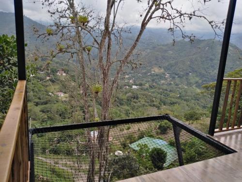 a balcony with a view of a valley at Glamping Bellavista in La Vega
