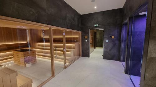 a dressing room with wooden cabinets and a hallway at Woodside apartments Kopaonik in Kopaonik
