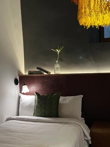 a bedroom with a large bed with a brown headboard at Casa Tunki in Cusco