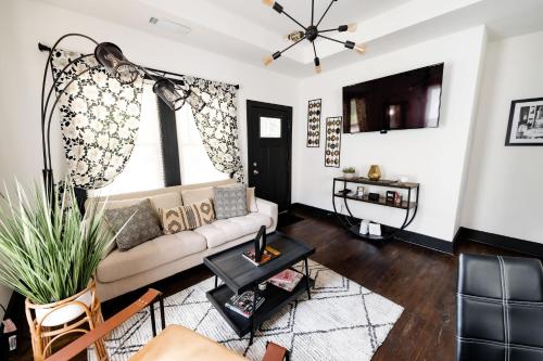 a living room with a couch and a tv at Cozy & Stylish Home in Downtown Atlanta in Atlanta