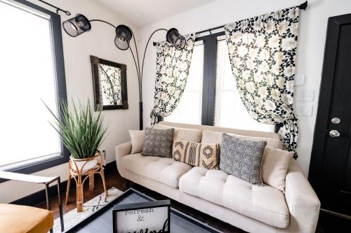 a living room with a white couch with pillows at Cozy & Stylish Home in Downtown Atlanta in Atlanta