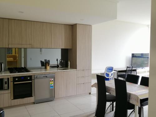 a kitchen and dining room with a table and chairs at Entire 1 Bedroom Security Apartment in Riverwood