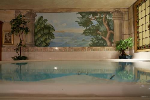 a pool of water in a room with a painting at Sunneschlössli Tannheimer Tal in Nesselwängle