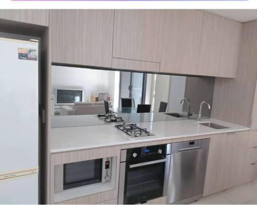 a kitchen with a sink and a stove top oven at 2-bedroom security apartment with free parking on premises in Riverwood