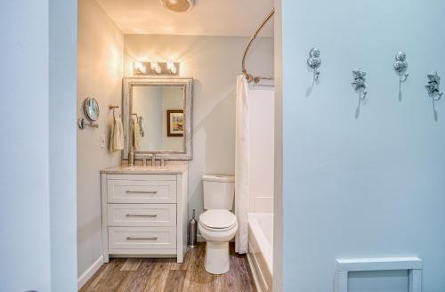 a bathroom with a toilet and a mirror at Bella Vista: Marshfront Condo 1 Block To The Beach. Pool & Hot Tub-1st Floor in Murrells Inlet