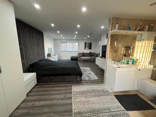 a bedroom with a bed and a living room at Penthouse Style Luxury 2 Bedroom House has Hot-Tub, extra fees apply in Birmingham