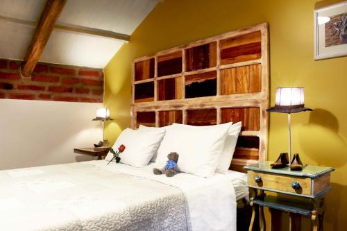 A bed or beds in a room at Old Town Quito Suites, Heritage Boutique Hotel, Where Every Detail Tells a Story