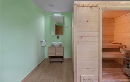 a bathroom with a sink and a wooden closet at Cozy Home In Lokve With Jacuzzi in Lokve