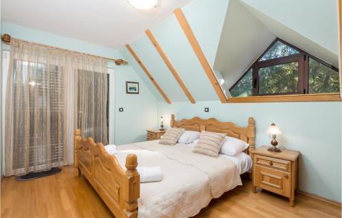a bedroom with a large bed and a large window at Cozy Home In Lokve With Jacuzzi in Lokve