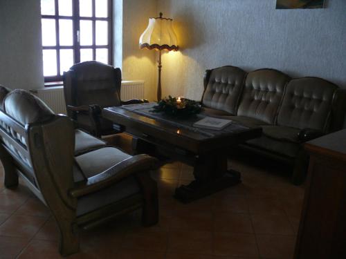 a living room with a couch and a table and chairs at Domek Kozacki in Łukowe