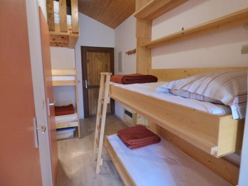 a room with two bunk beds and a ladder at Studio Le Grand-Bornand, 1 pièce, 6 personnes - FR-1-458-173 in Le Grand-Bornand